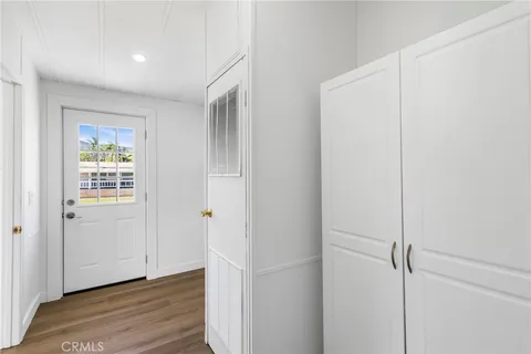 a view of an empty room with closet and a window