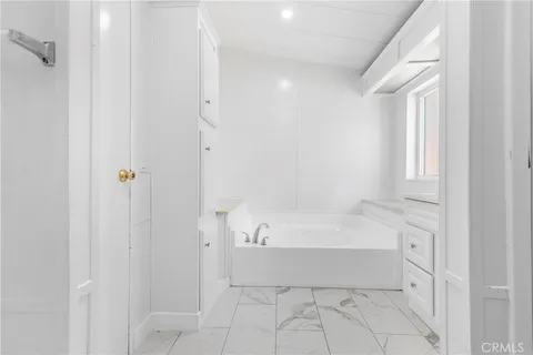 a spacious bathroom with a bathtub and a shower