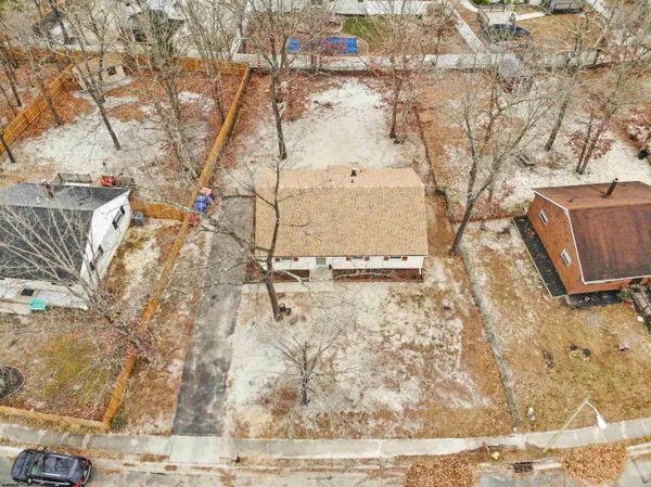 a view of a yard with wooden fence