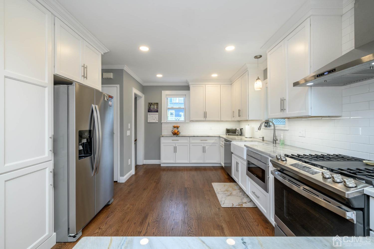1221 Beech Avenue Mountainside, NJ 07092 - Photo 13 of 46 a kitchen with wooden floors and stainless steel appliances
