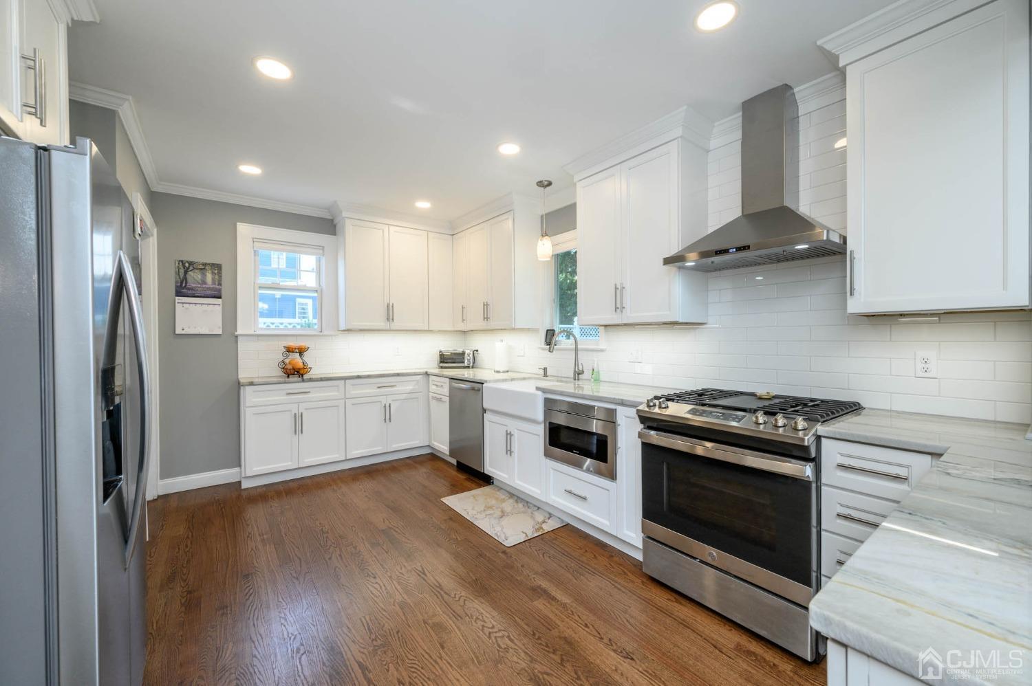 1221 Beech Avenue Mountainside, NJ 07092 - Photo 14 of 46 a kitchen with stainless steel appliances white cabinets and a stove