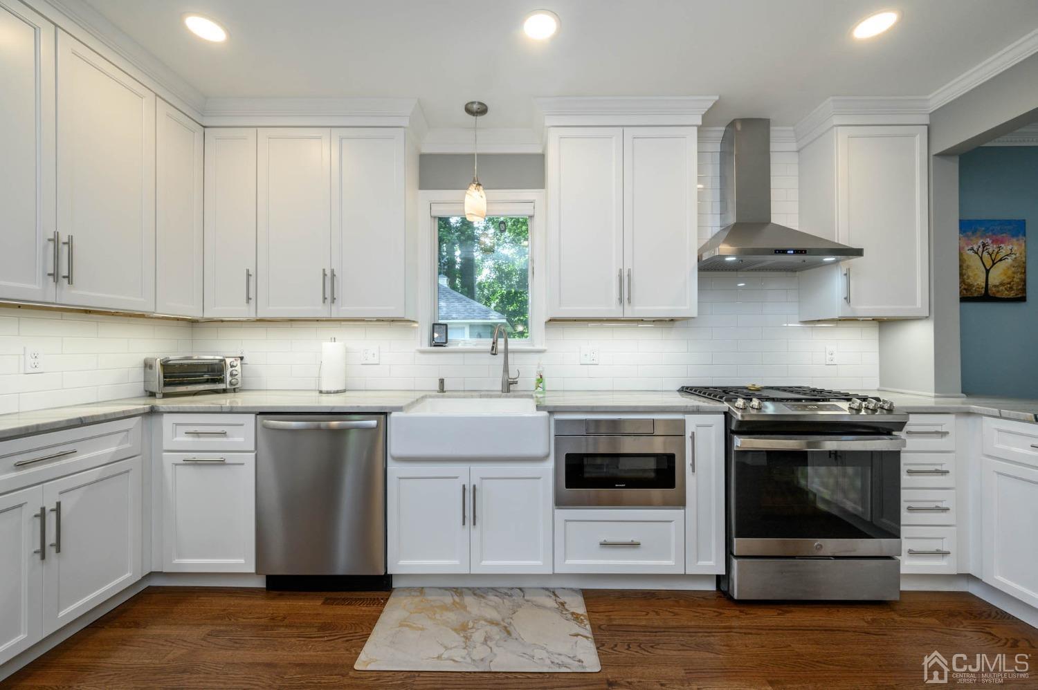 1221 Beech Avenue Mountainside, NJ 07092 - Photo 15 of 46 a kitchen with stainless steel appliances granite countertop a stove and white cabinets