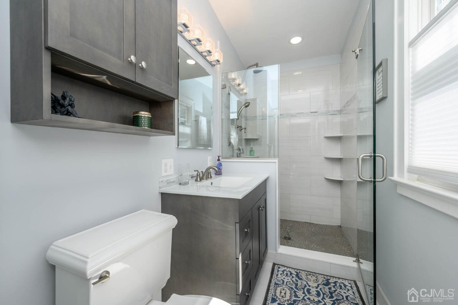 1221 Beech Avenue Mountainside, NJ 07092 - Photo 24 of 46 a bathroom with a sink a toilet and shower