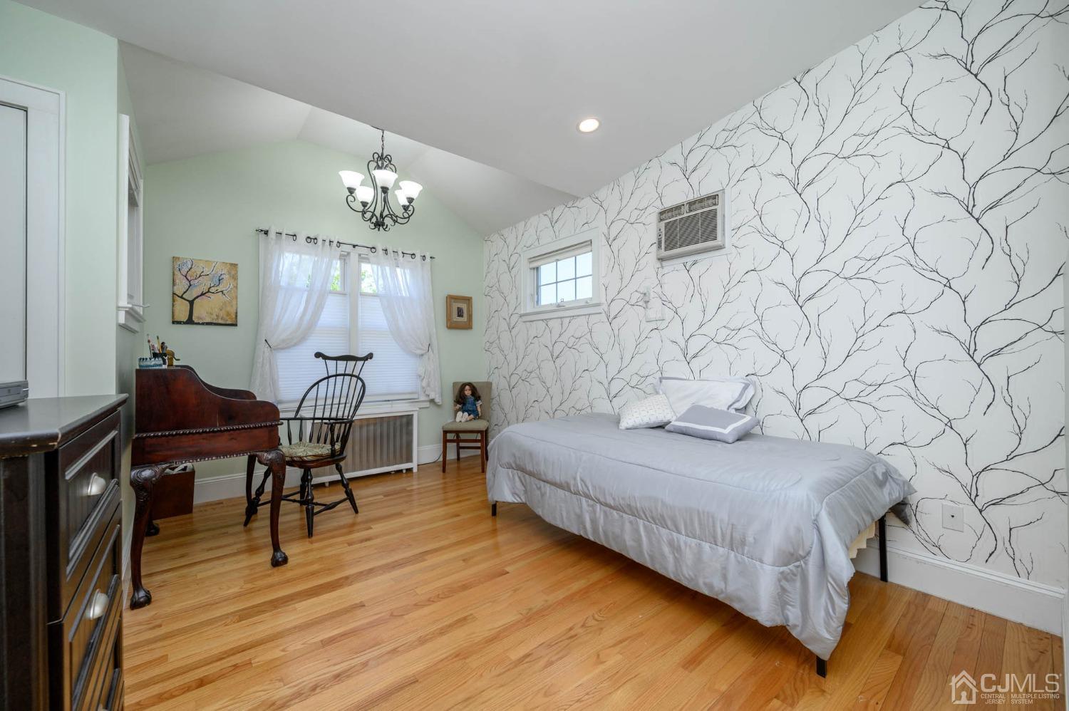 1221 Beech Avenue Mountainside, NJ 07092 - Photo 29 of 46 a bedroom with a bed and a chandelier