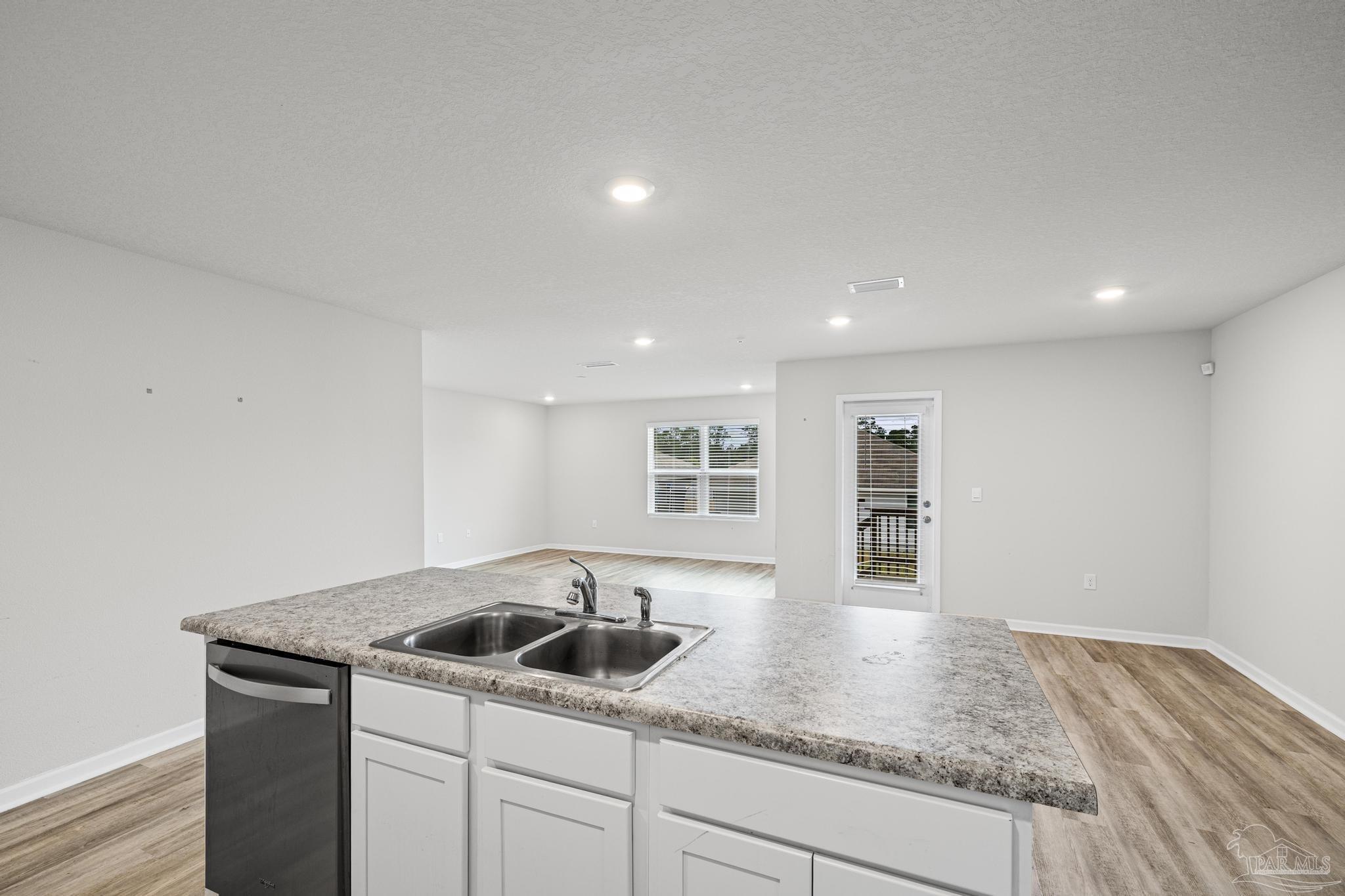 5771 Belmont Stakes Road Pensacola, FL 32526 - Photo 11 of 36 a kitchen with a sink and cabinets