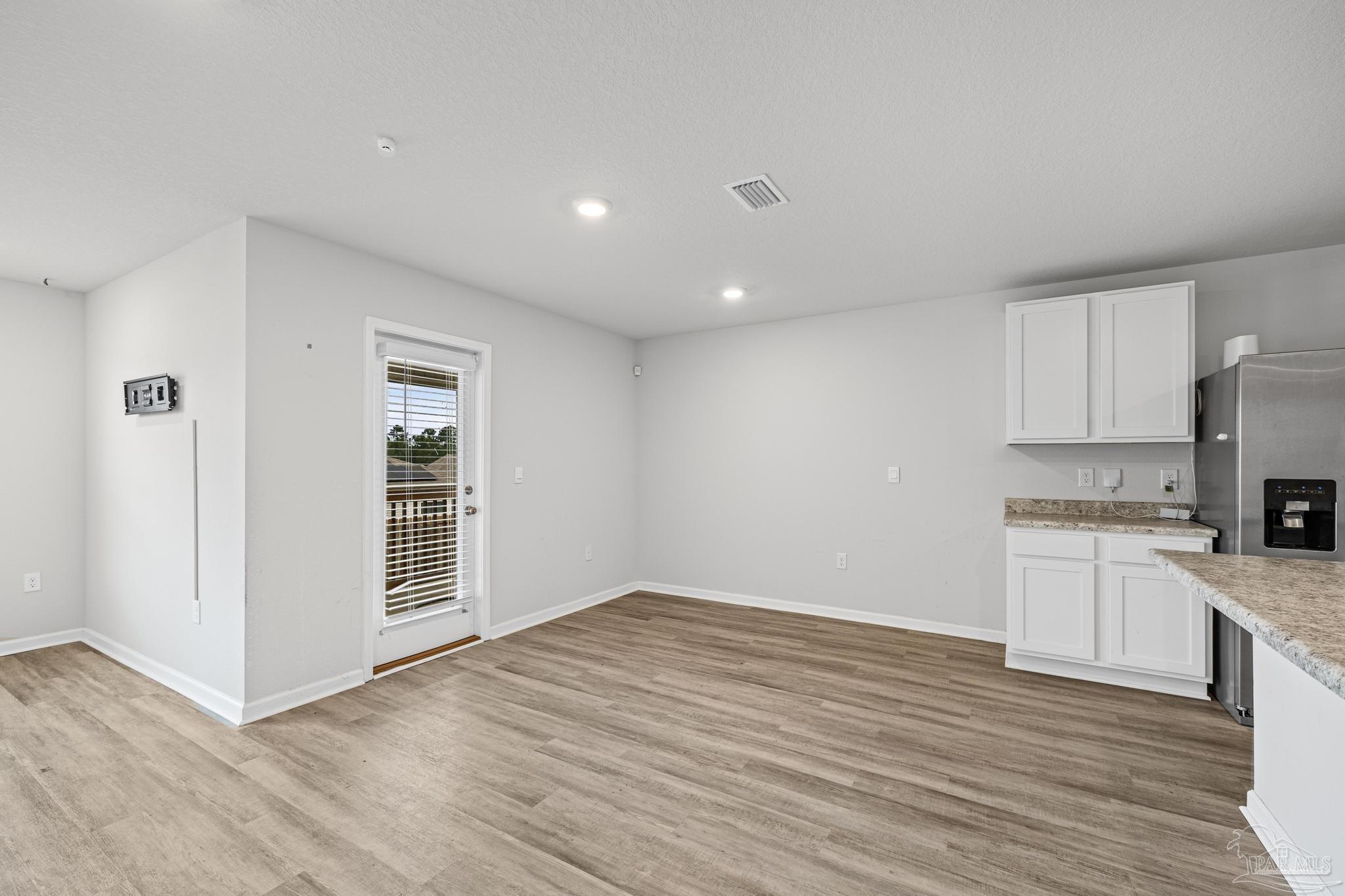 5771 Belmont Stakes Road Pensacola, FL 32526 - Photo 14 of 36 a view of a kitchen with wooden floor and a sink