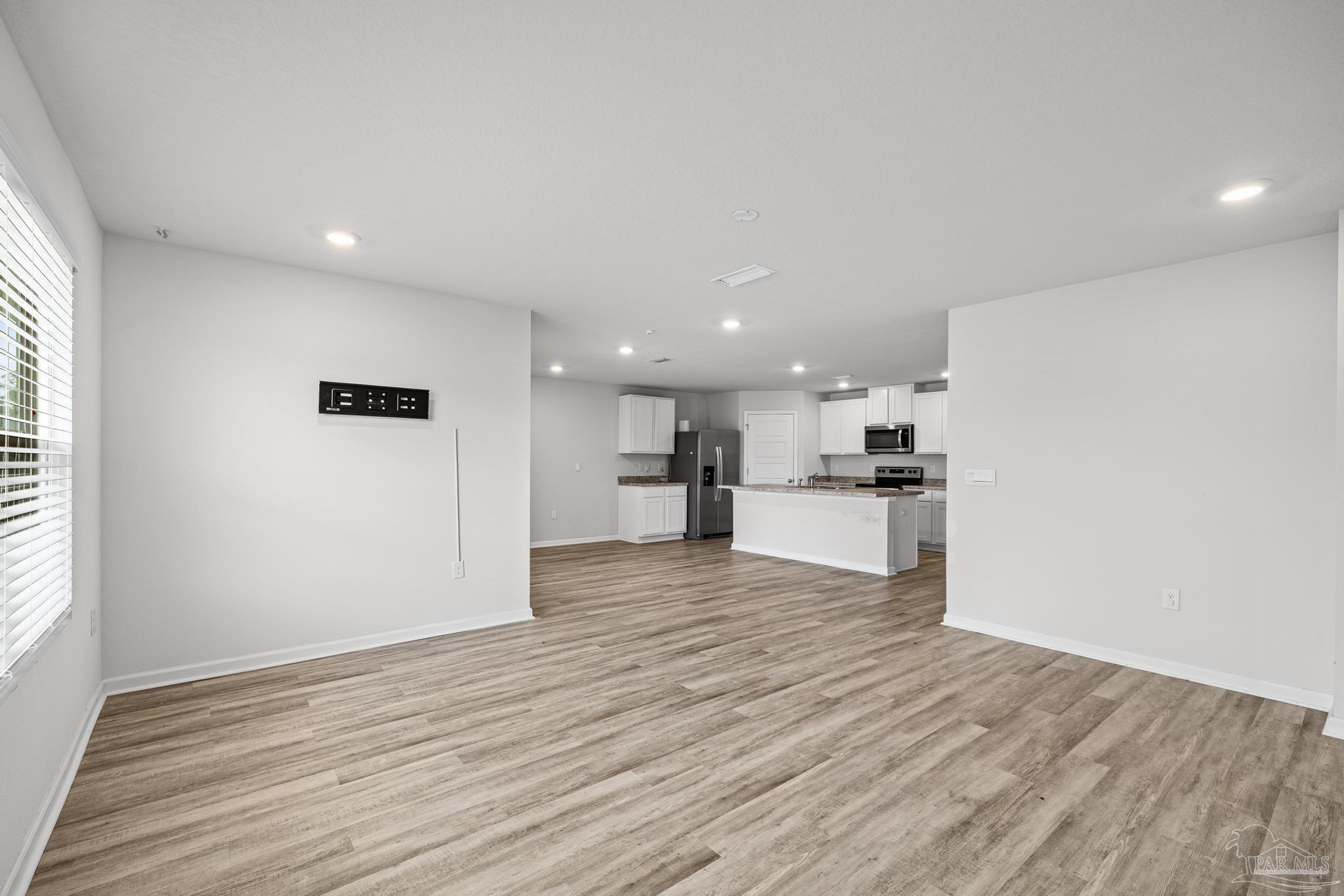 5771 Belmont Stakes Road Pensacola, FL 32526 - Photo 15 of 36 a view of kitchen view wooden floor and window