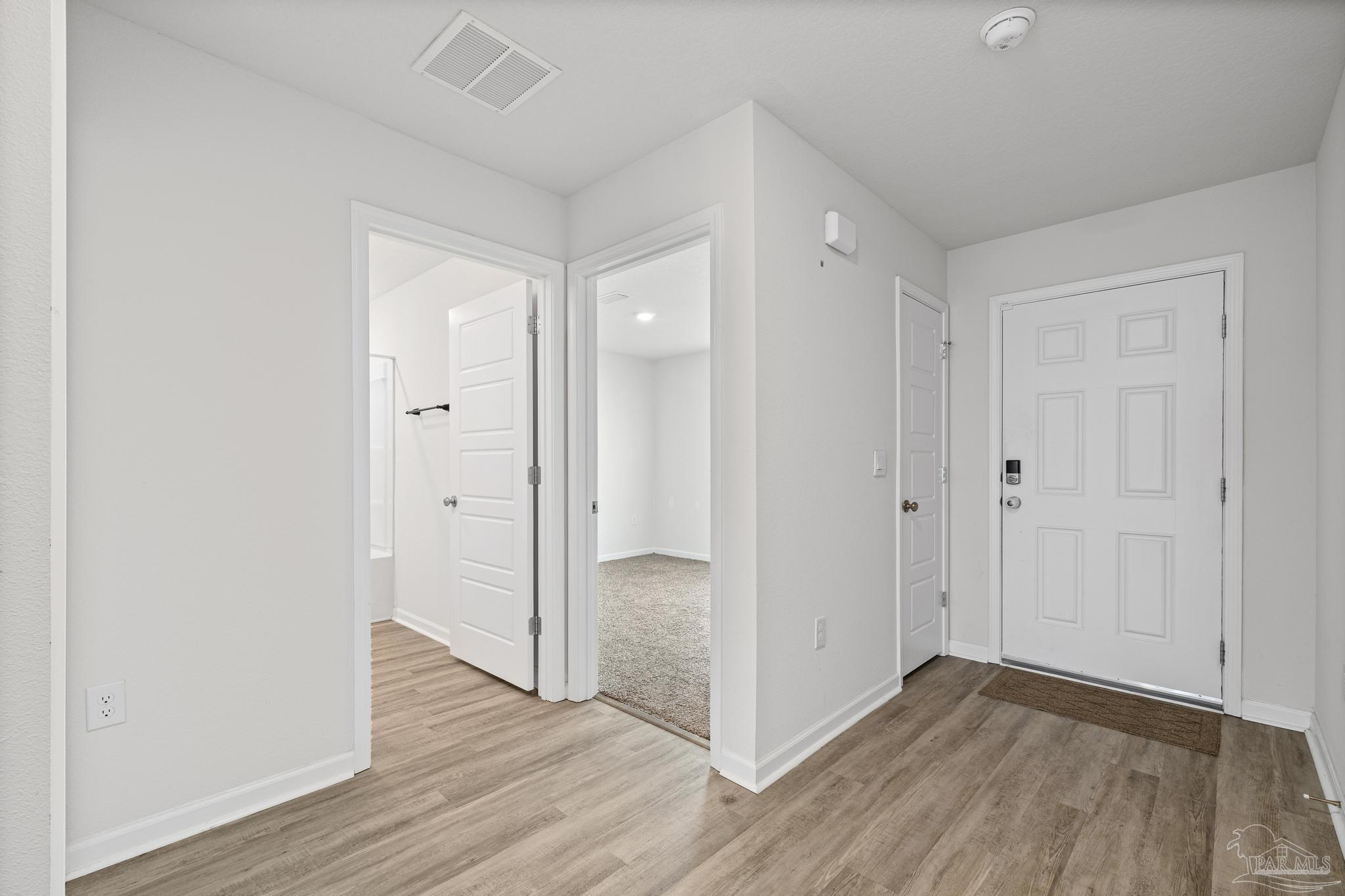 5771 Belmont Stakes Road Pensacola, FL 32526 - Photo 17 of 36 a view of hallway with wooden floor