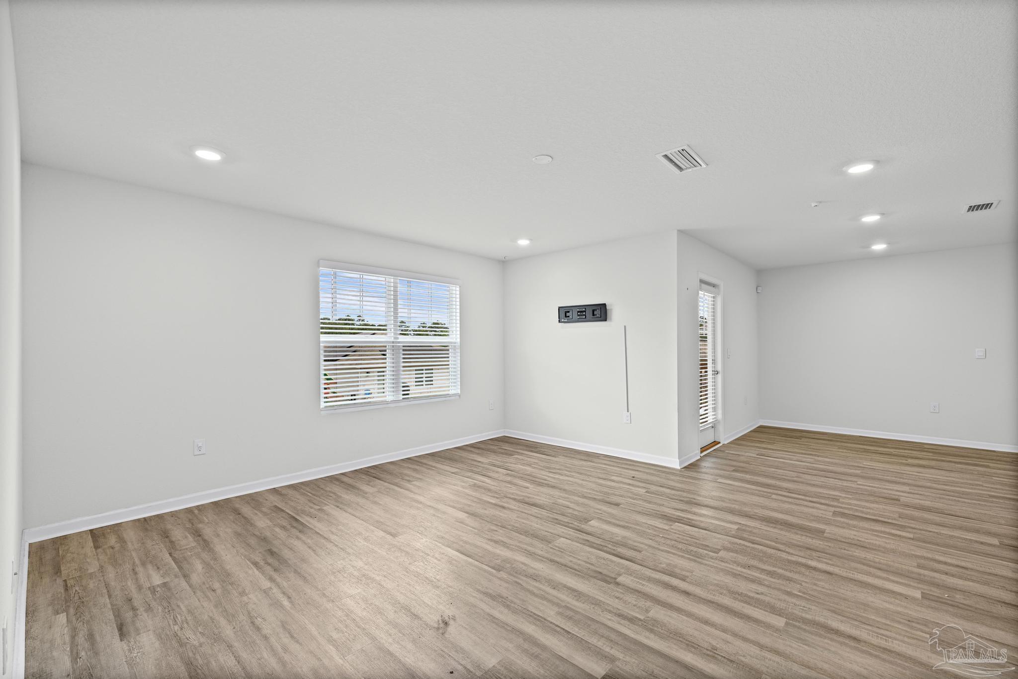 5771 Belmont Stakes Road Pensacola, FL 32526 - Photo 18 of 36 an empty room with wooden floor and window