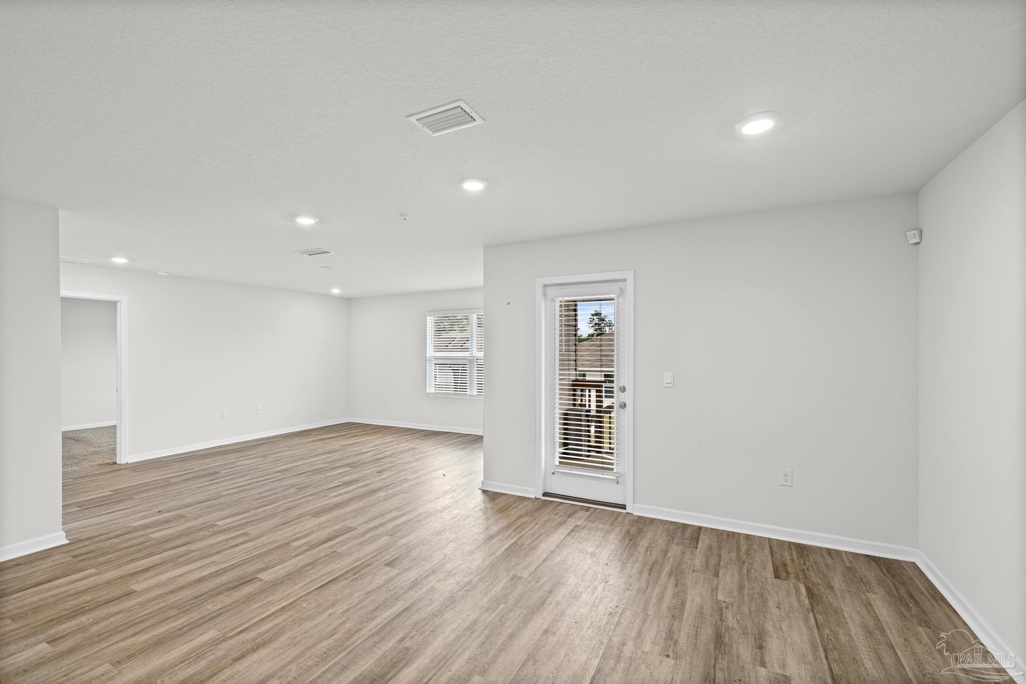 5771 Belmont Stakes Road Pensacola, FL 32526 - Photo 19 of 36 wooden floor in an empty room with a window