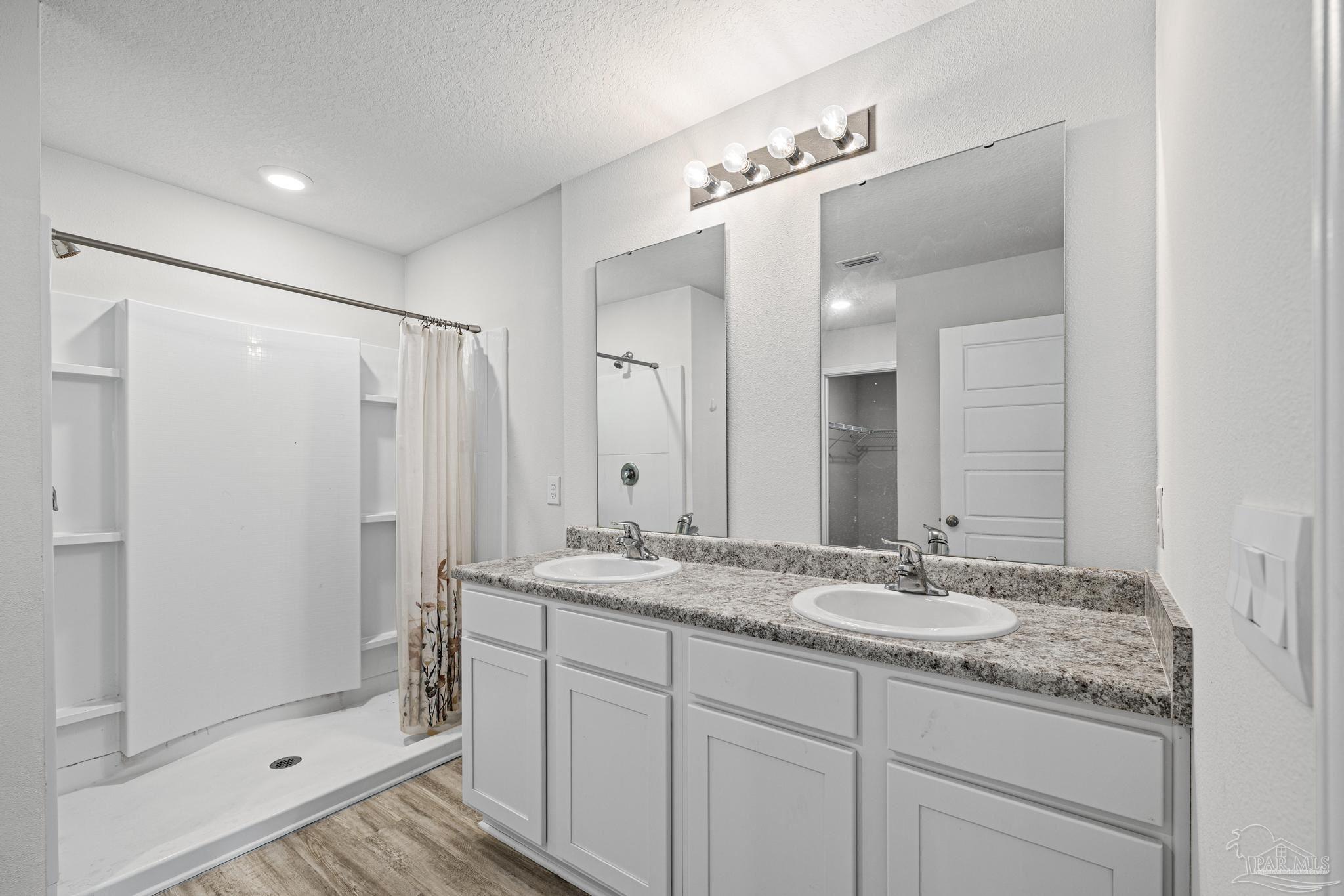 5771 Belmont Stakes Road Pensacola, FL 32526 - Photo 20 of 36 a bathroom with a granite countertop sink mirror and double