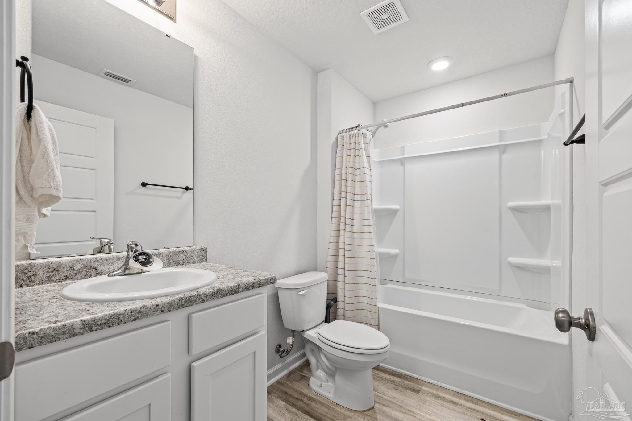 5771 Belmont Stakes Road Pensacola, FL 32526 - Photo 25 of 36 a bathroom with a sink toilet vanity and shower