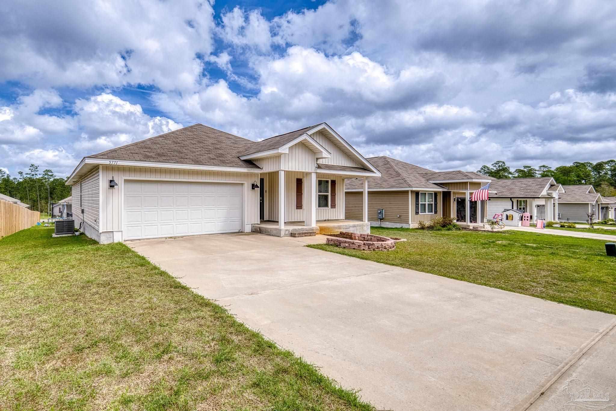 5771 Belmont Stakes Road Pensacola, FL 32526 - Photo 30 of 36 a front view of a house with a garden