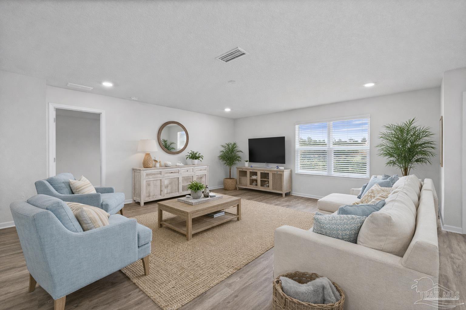 5771 Belmont Stakes Road Pensacola, FL 32526 - Photo 3 of 36 a living room with furniture a rug and a flat screen tv
