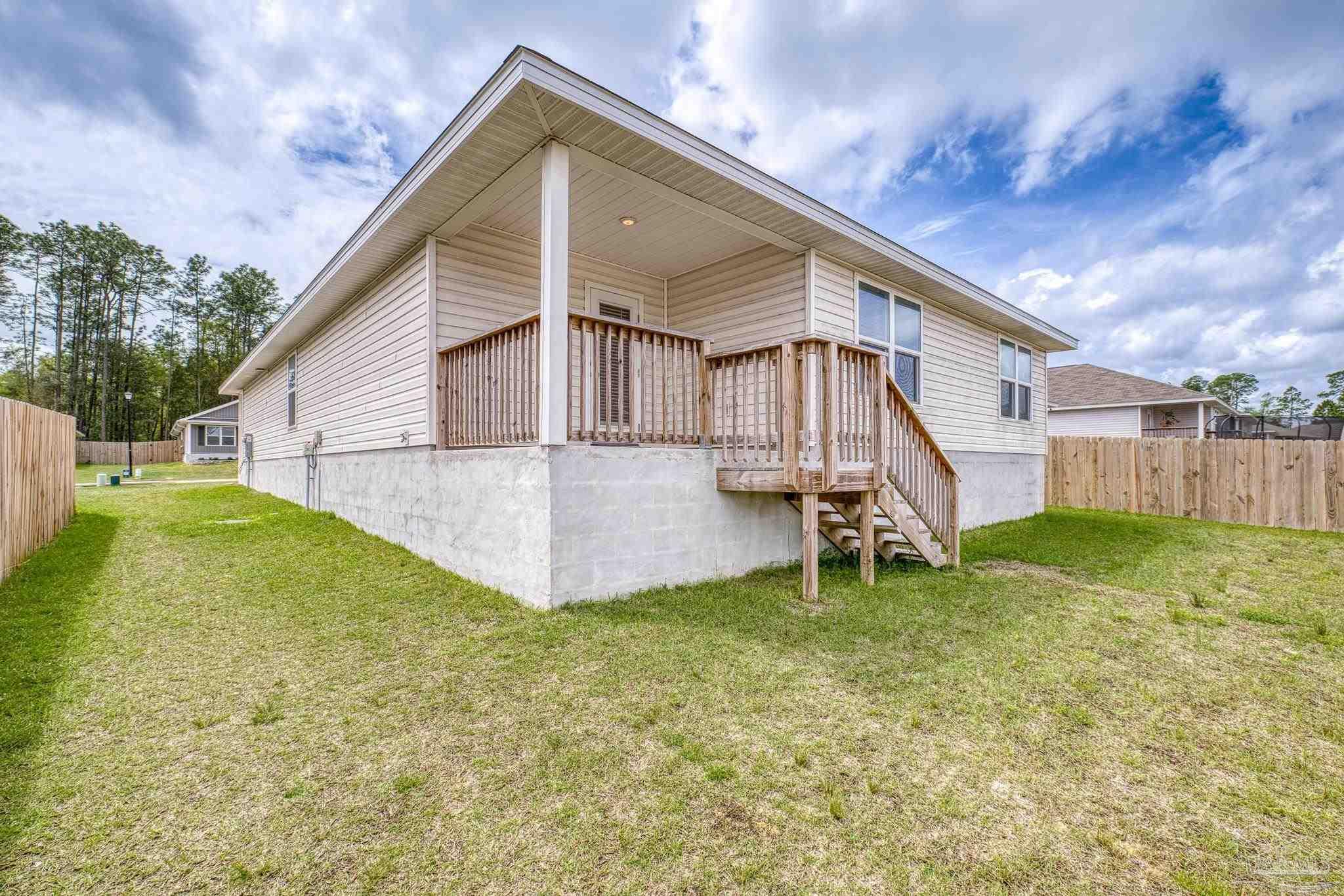 5771 Belmont Stakes Road Pensacola, FL 32526 - Photo 32 of 36 a view of a house with a yard
