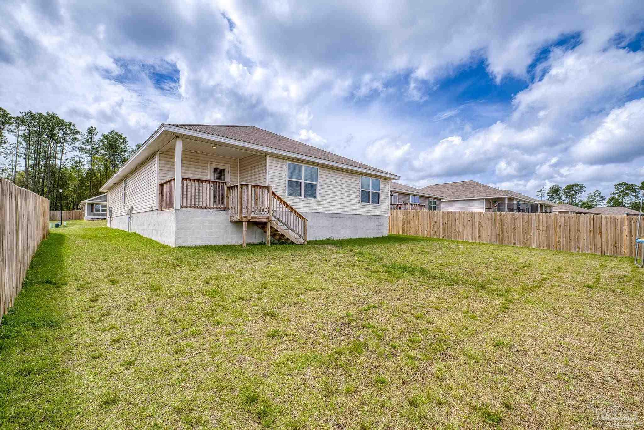 5771 Belmont Stakes Road Pensacola, FL 32526 - Photo 33 of 36 a front view of a house with garden