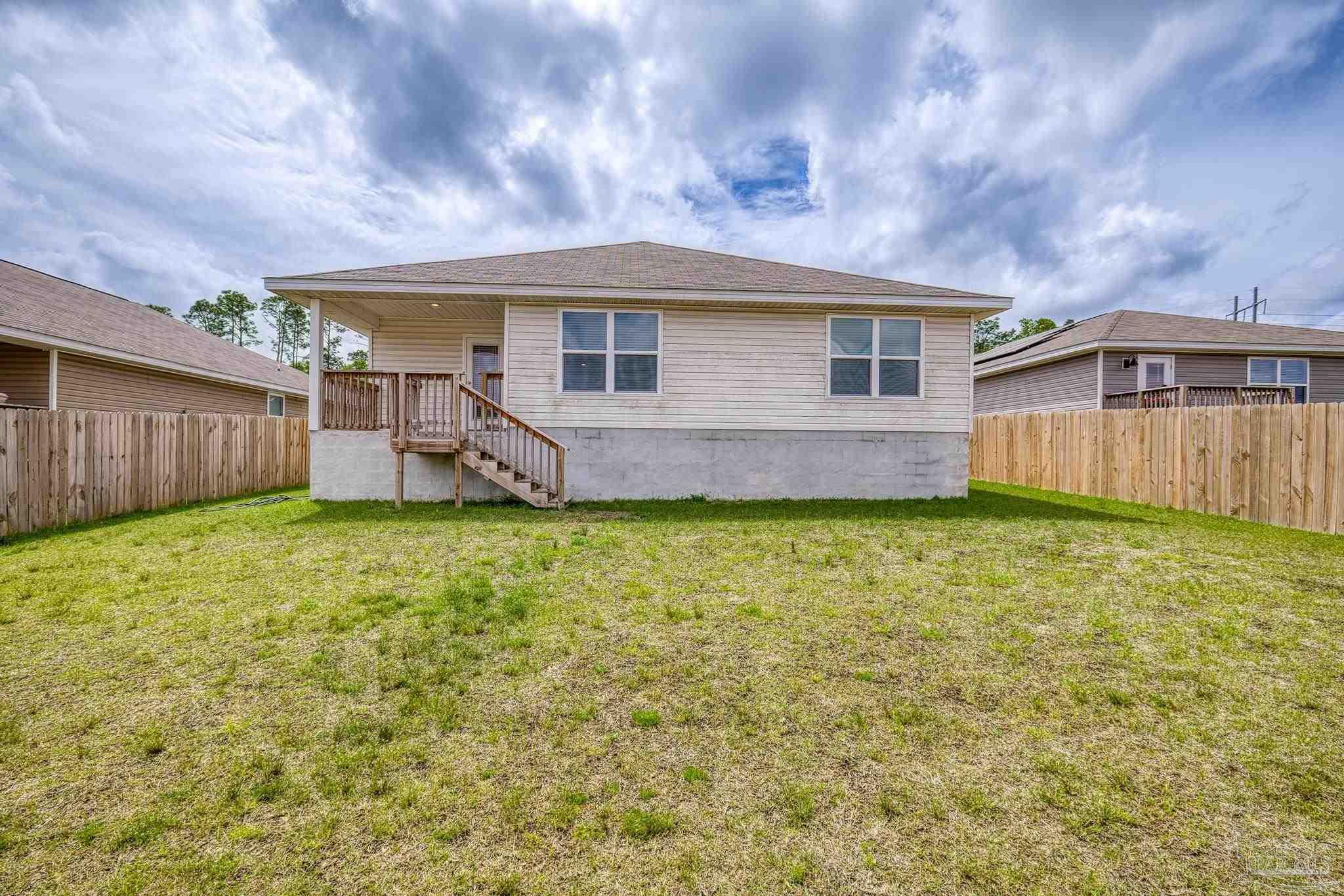 5771 Belmont Stakes Road Pensacola, FL 32526 - Photo 34 of 36 a front view of a house with garden