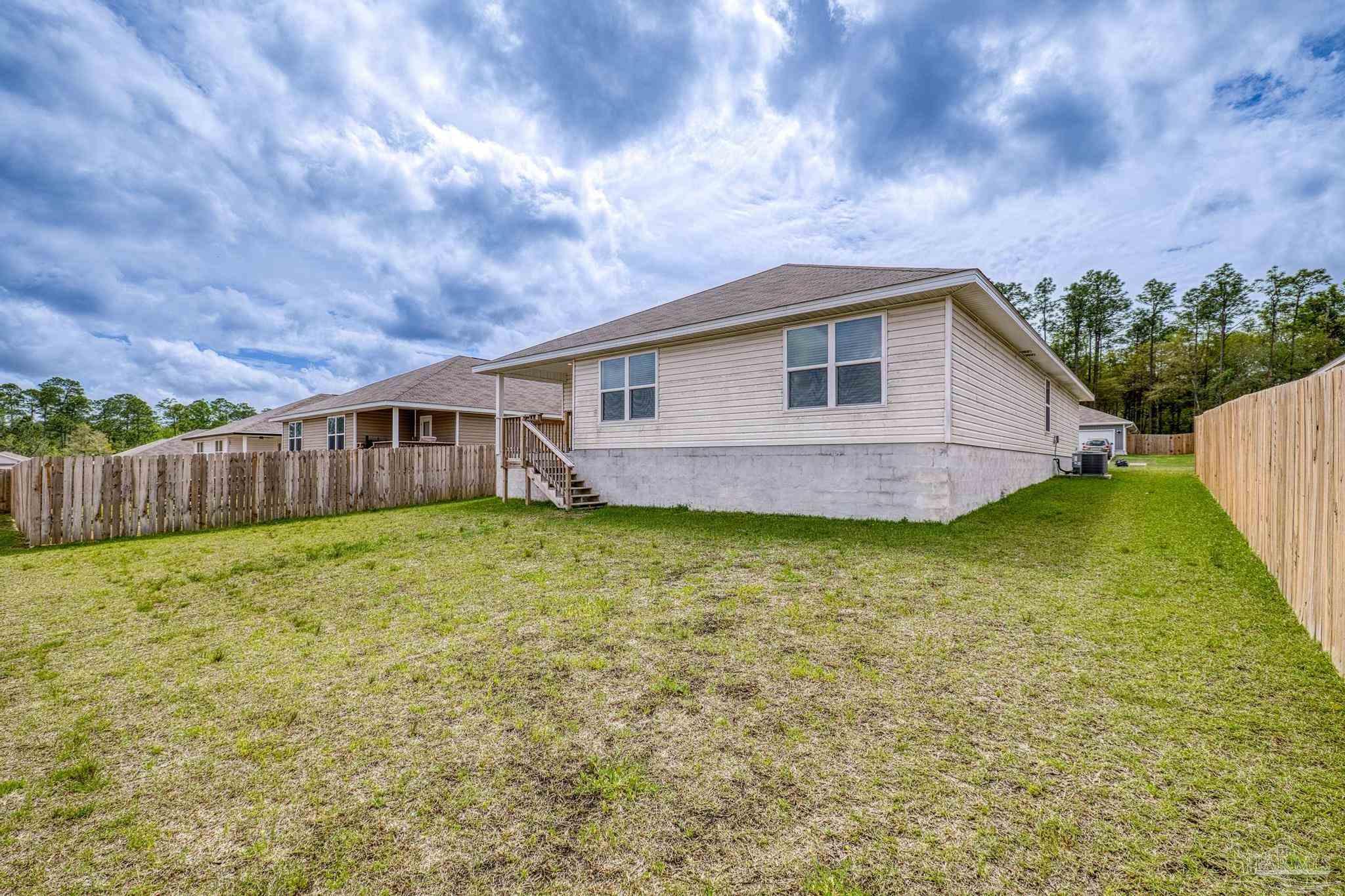 5771 Belmont Stakes Road Pensacola, FL 32526 - Photo 35 of 36 a view of a house with a backyard
