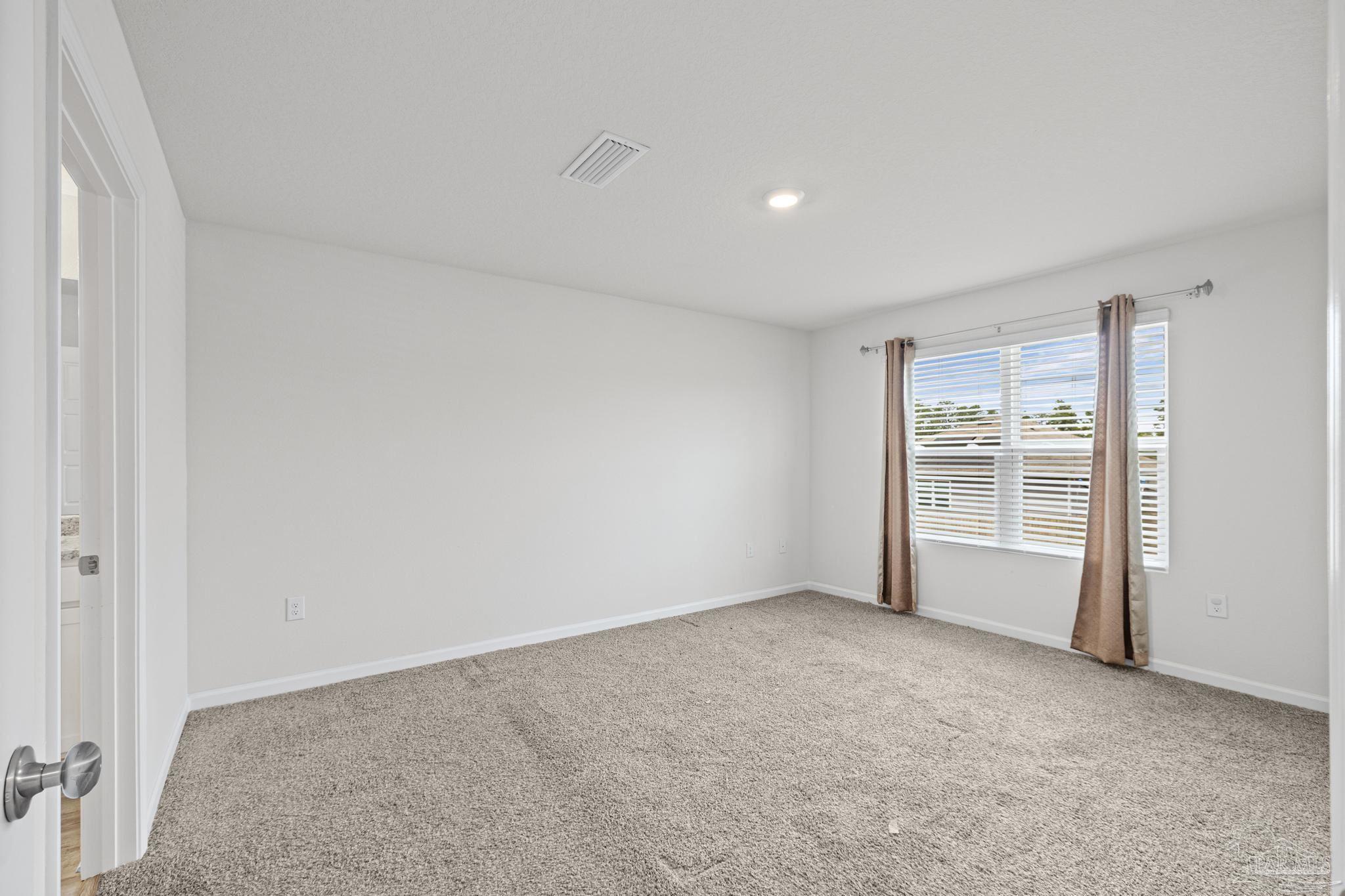 5771 Belmont Stakes Road Pensacola, FL 32526 - Photo 6 of 36 a view of an empty room with a window
