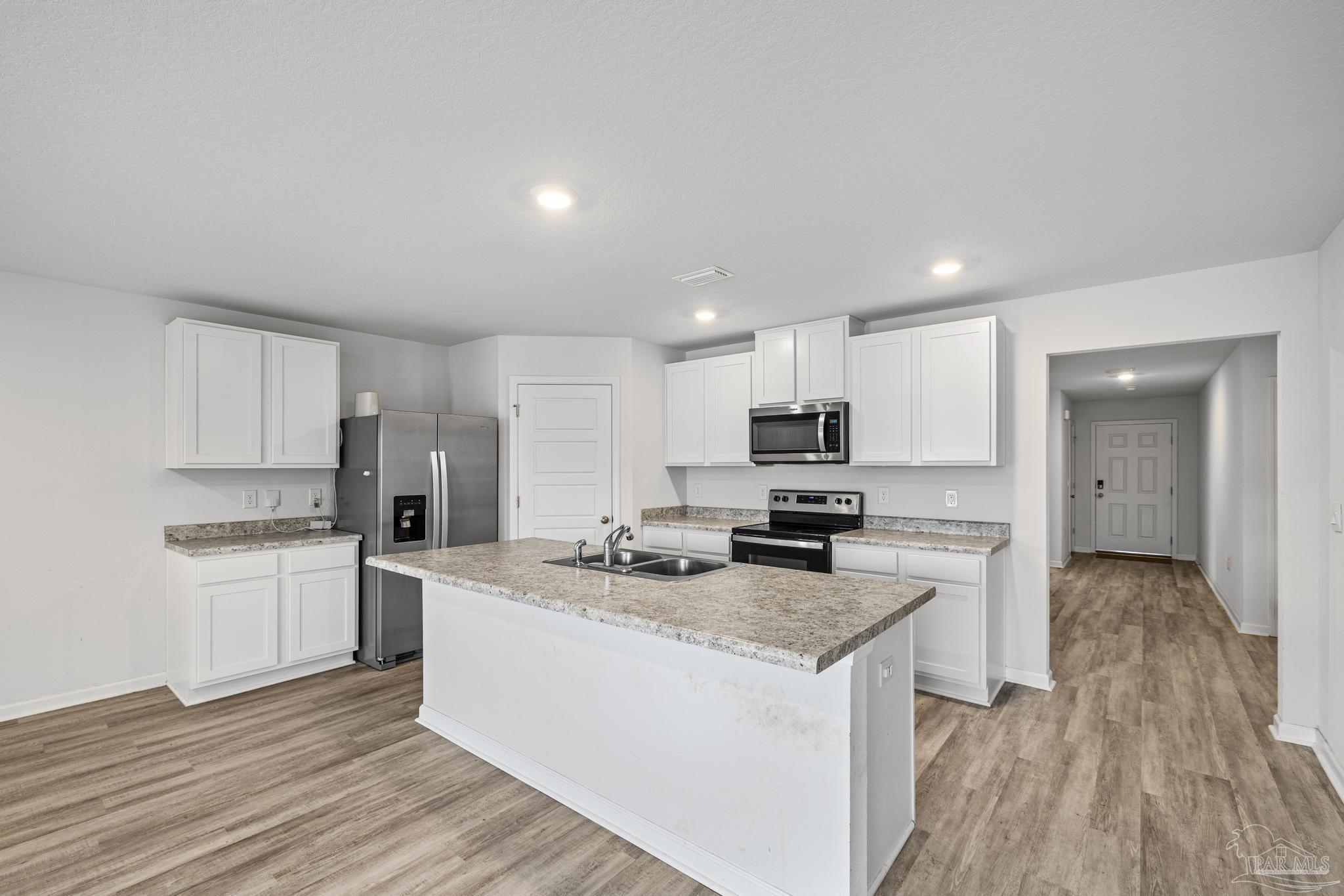 5771 Belmont Stakes Road Pensacola, FL 32526 - Photo 7 of 36 a kitchen with stainless steel appliances granite countertop a sink stove and refrigerator