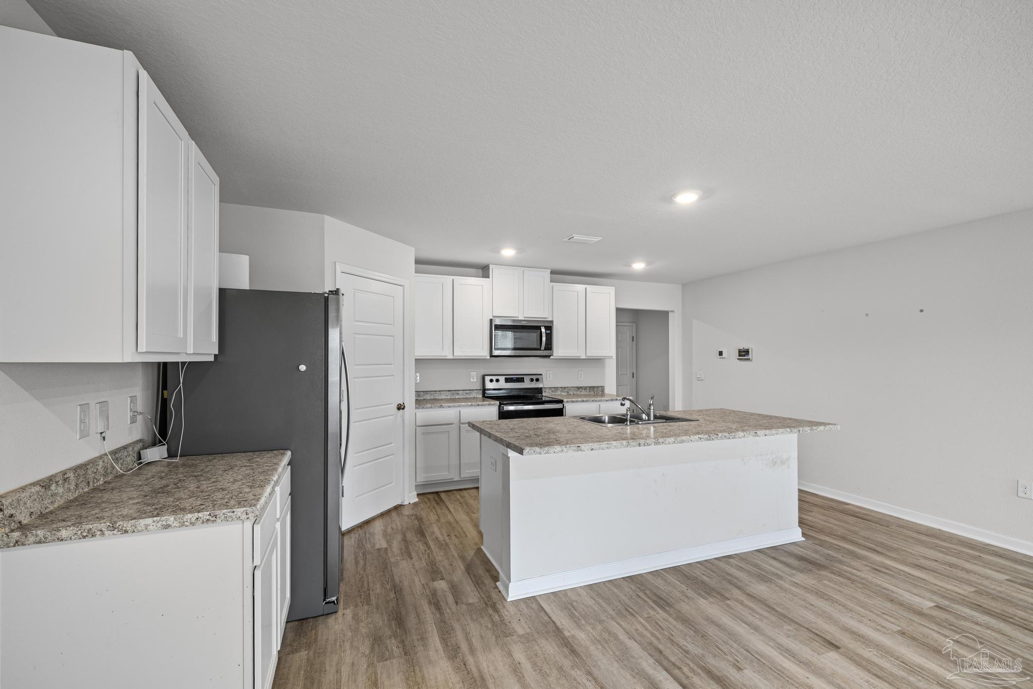 5771 Belmont Stakes Road Pensacola, FL 32526 - Photo 8 of 36 a kitchen with stainless steel appliances granite countertop a sink stove and refrigerator