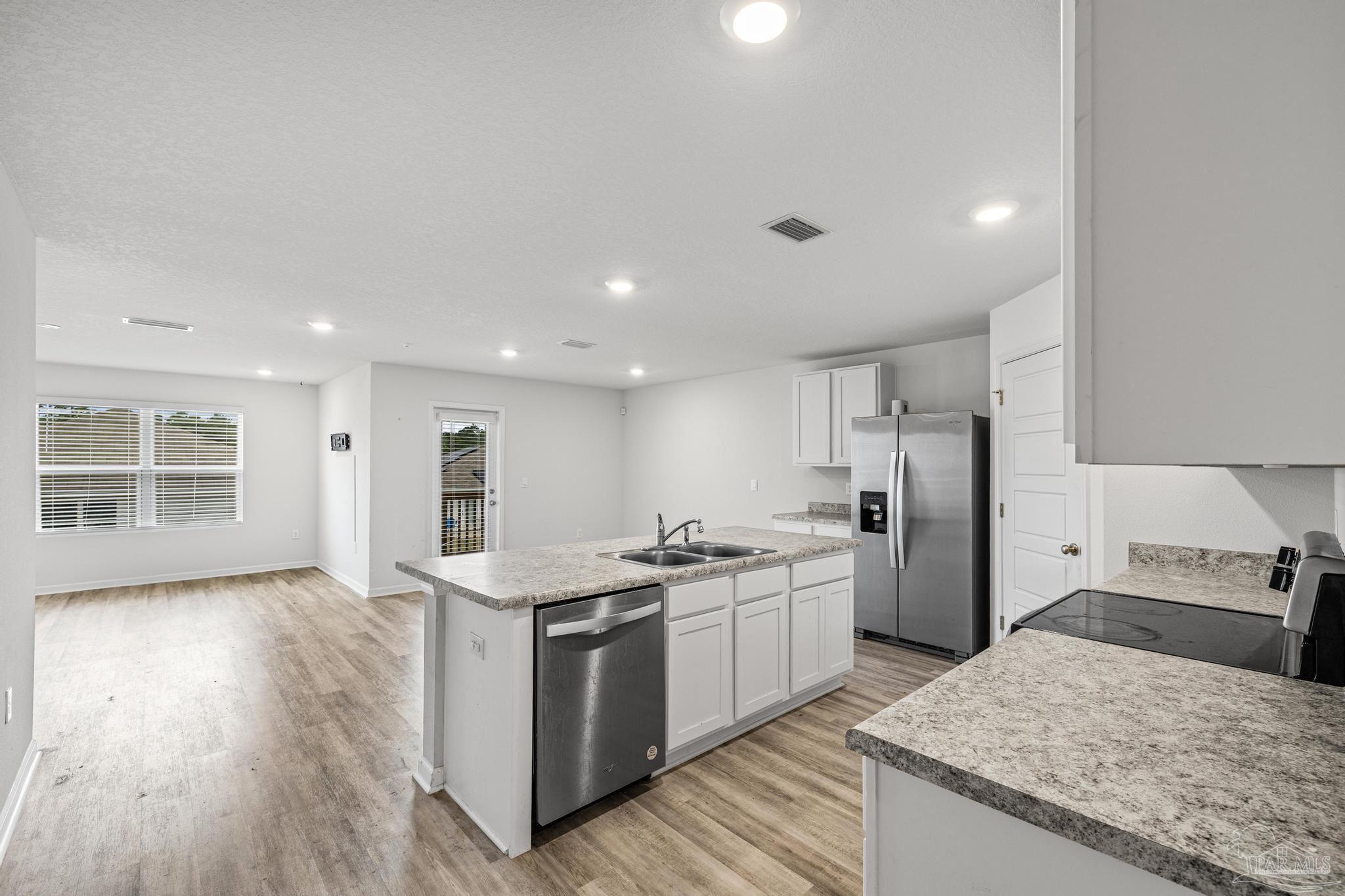 5771 Belmont Stakes Road Pensacola, FL 32526 - Photo 10 of 36 a kitchen with stainless steel appliances granite countertop a sink stove and refrigerator