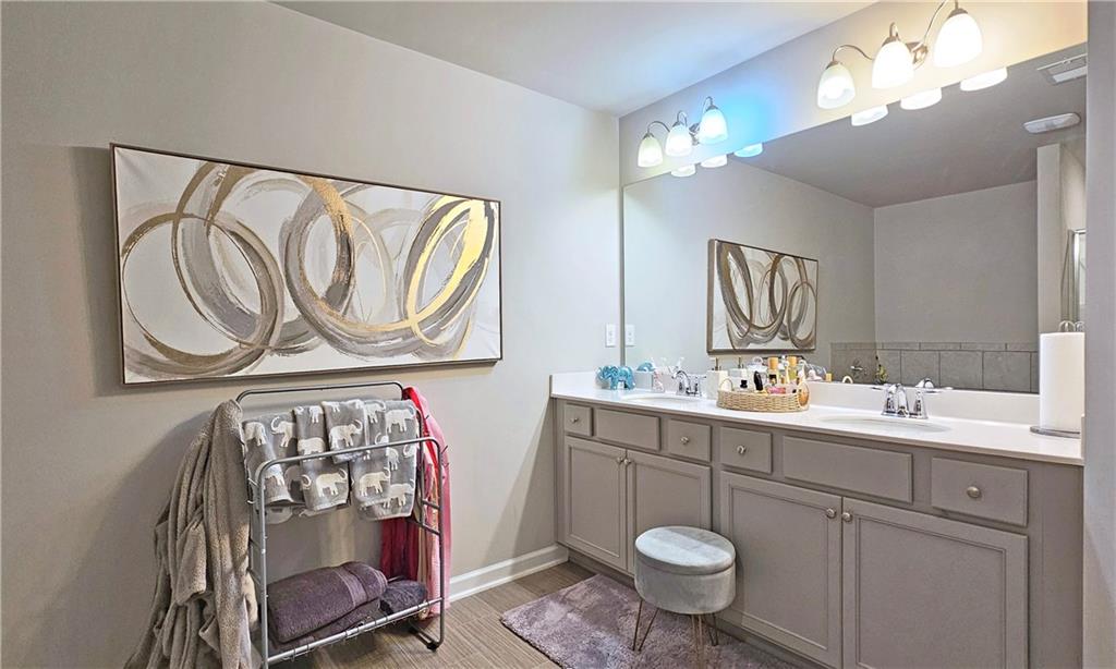 3401 Endurance Court, Unit 10 Atlanta, GA 30349 - Photo 11 of 17 a bathroom with a toilet a sink and mirror