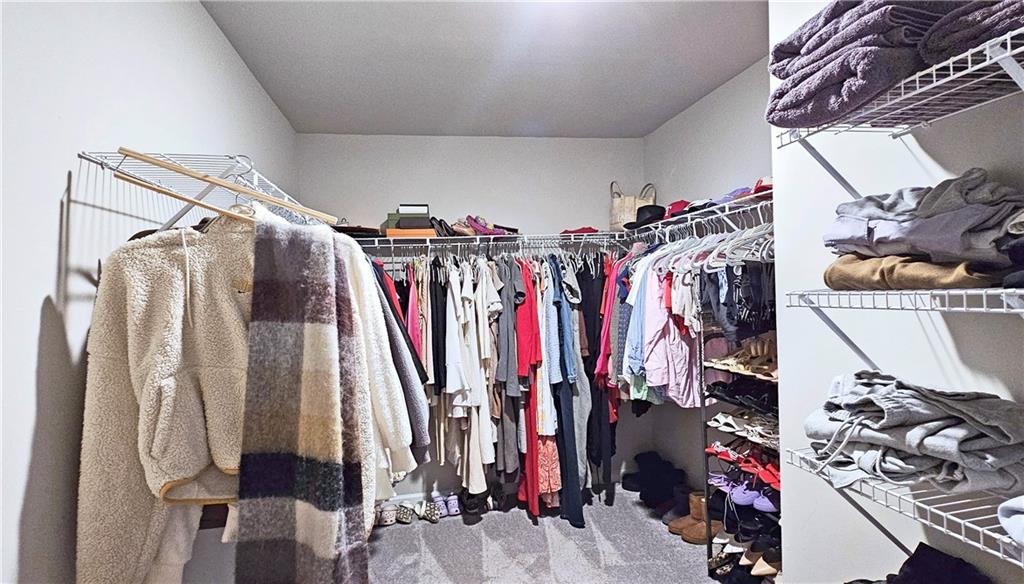 3401 Endurance Court, Unit 10 Atlanta, GA 30349 - Photo 12 of 17 a view of walk in closet with clothes