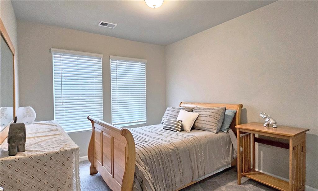 3401 Endurance Court, Unit 10 Atlanta, GA 30349 - Photo 13 of 17 a bedroom with a bed and a window