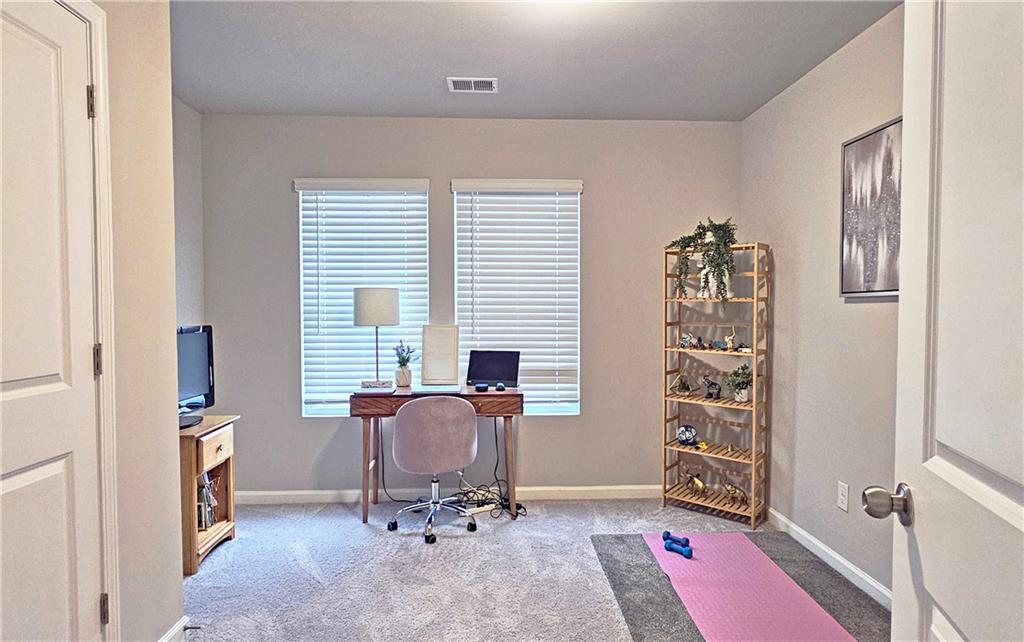 3401 Endurance Court, Unit 10 Atlanta, GA 30349 - Photo 15 of 17 a view of a workspace with furniture and a window
