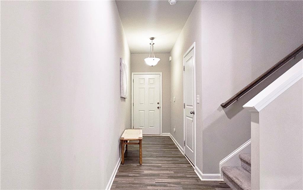 3401 Endurance Court, Unit 10 Atlanta, GA 30349 - Photo 2 of 17 a view of a hallway with wooden floor and staircase