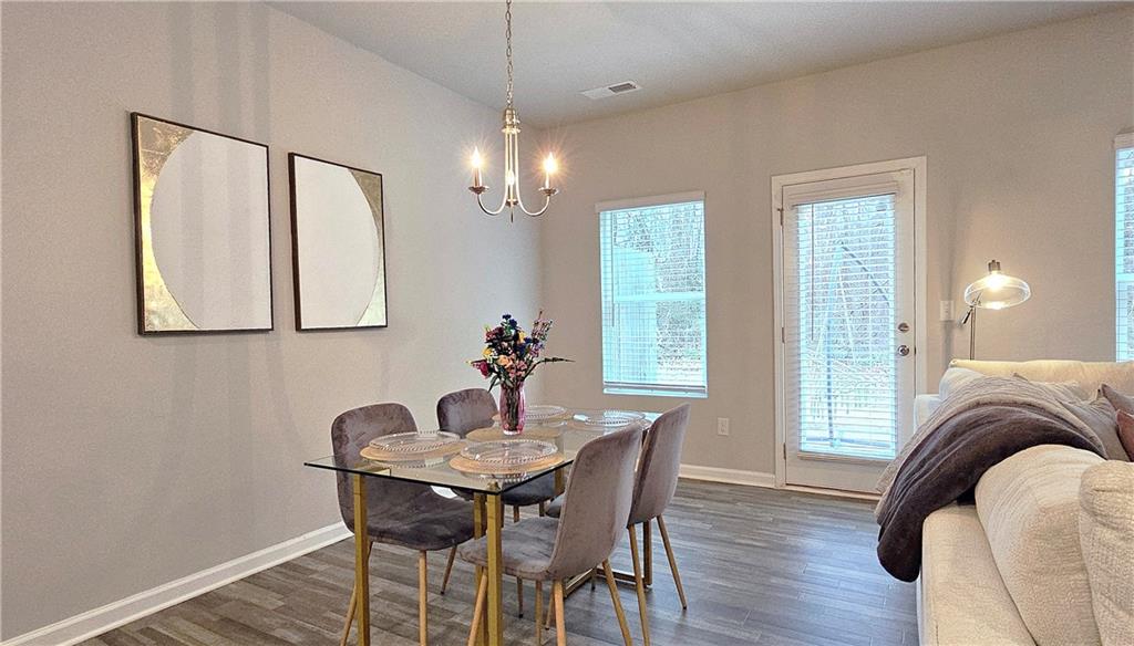 3401 Endurance Court, Unit 10 Atlanta, GA 30349 - Photo 5 of 17 a view of a dining room with furniture window and wooden floor