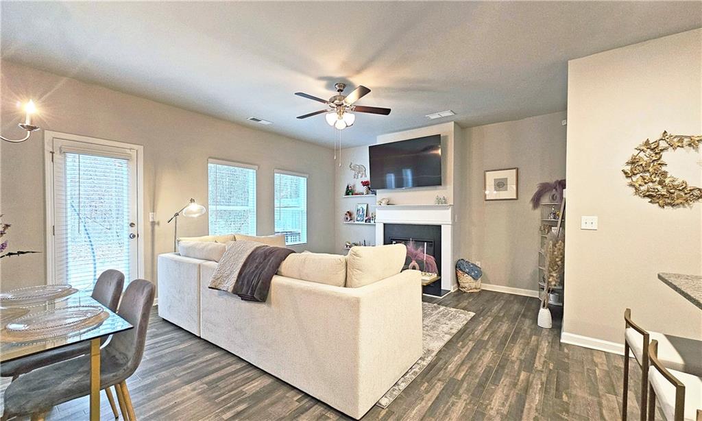 3401 Endurance Court, Unit 10 Atlanta, GA 30349 - Photo 6 of 17 a living room with furniture a fireplace and a table