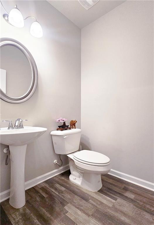 3401 Endurance Court, Unit 10 Atlanta, GA 30349 - Photo 7 of 17 a bathroom with a toilet sink and mirror