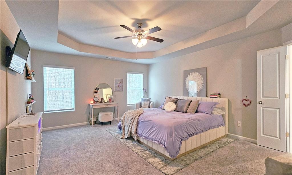 3401 Endurance Court, Unit 10 Atlanta, GA 30349 - Photo 8 of 17 a bedroom with a large bed and a chandelier