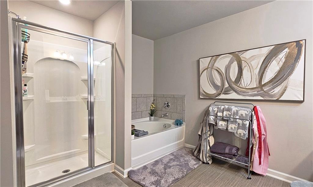 3401 Endurance Court, Unit 10 Atlanta, GA 30349 - Photo 10 of 17 a bathroom with a bathtub and a shower