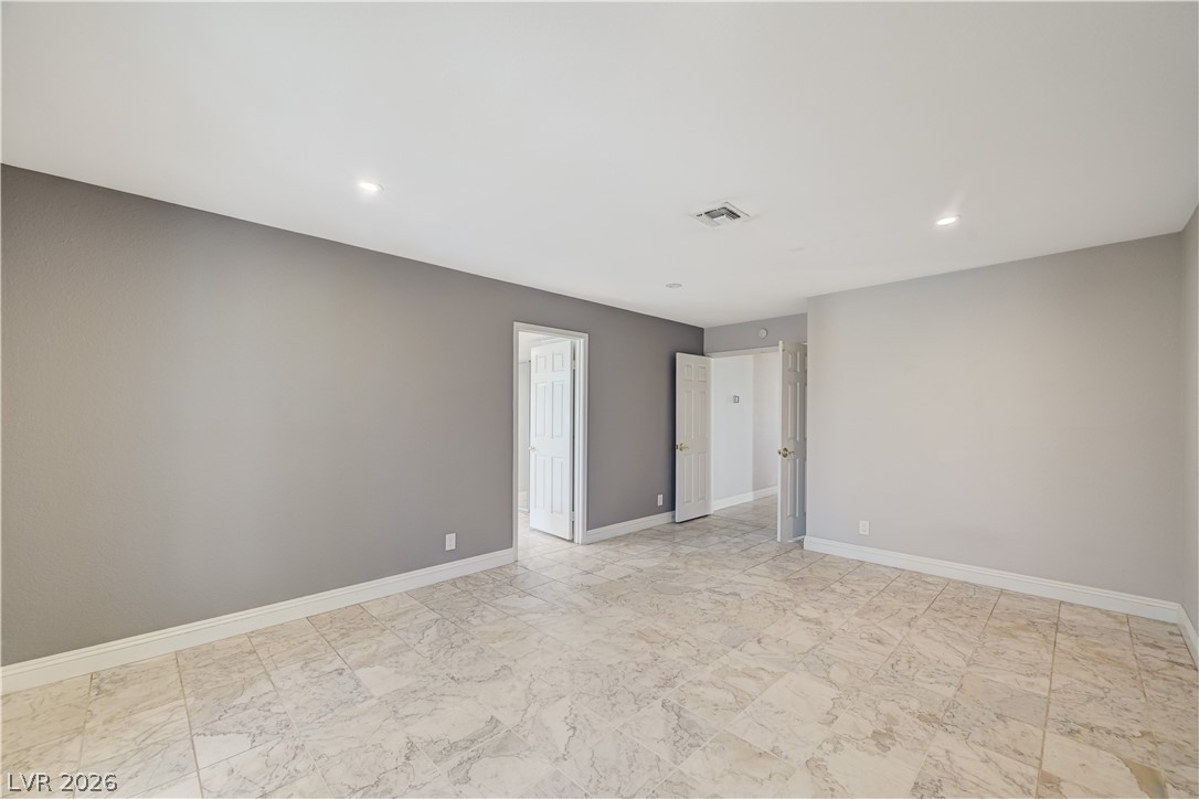 6635 Costa Brava Road Las Vegas, NV 89146 - Photo 27 of 59 Recessed lighting illuminates this versatile room, featuring elegant tile flooring throughout.