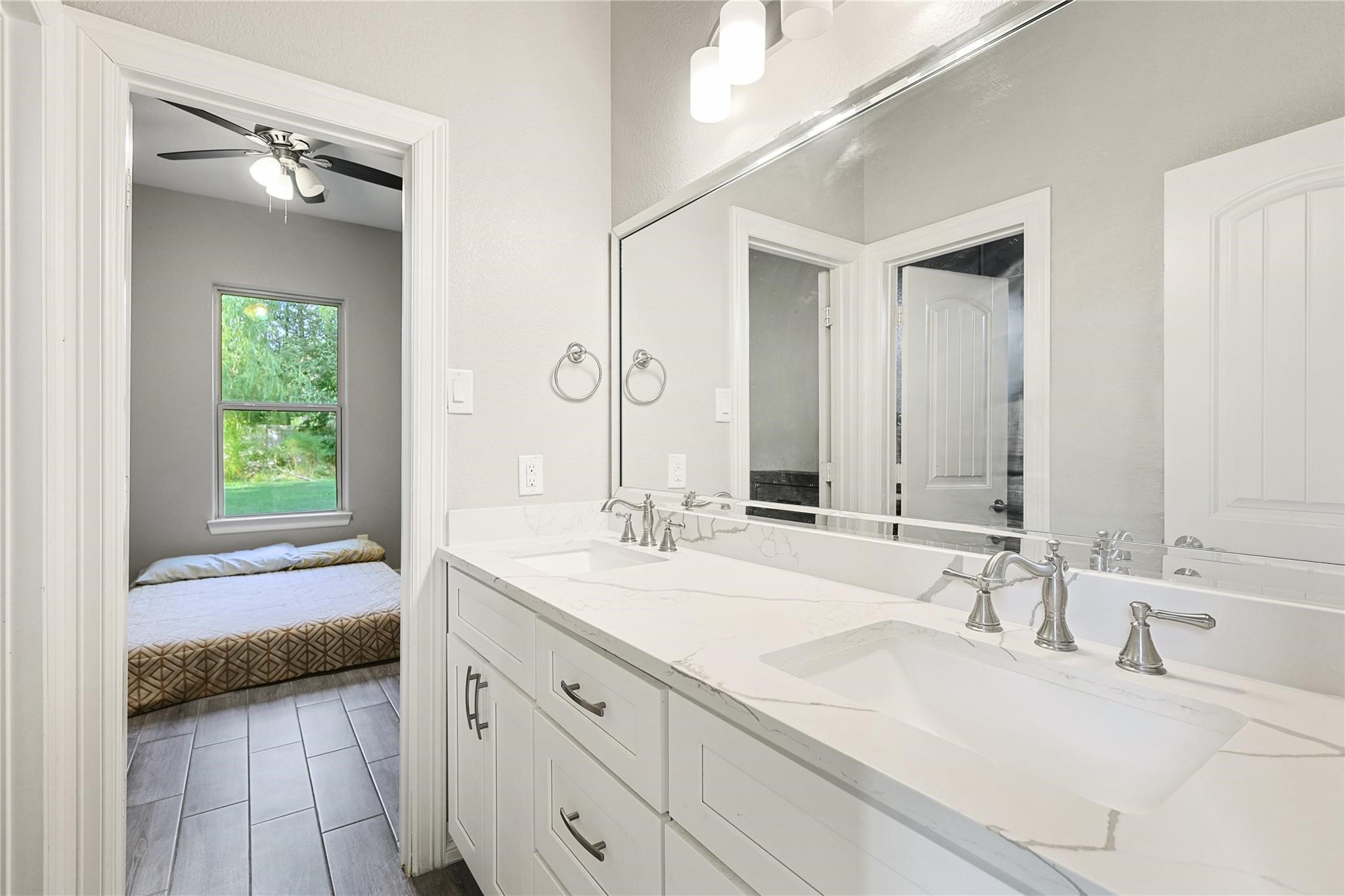 642 Parthenon Place New Caney, TX 77357 - Photo 20 of 30 a en suite bathroom with a double vanity sink and a mirror