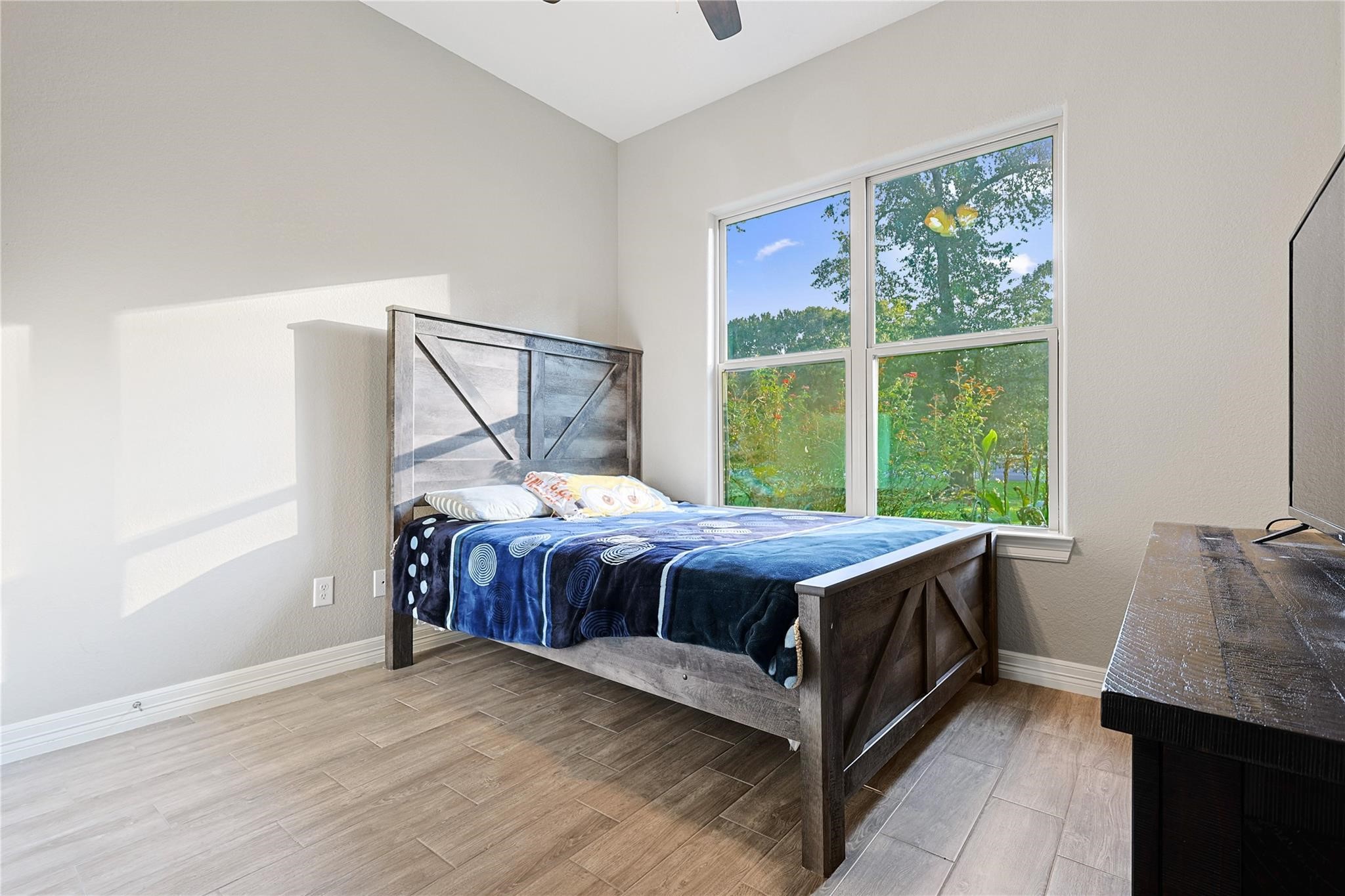 642 Parthenon Place New Caney, TX 77357 - Photo 21 of 30 a bedroom with a bed and wooden floor