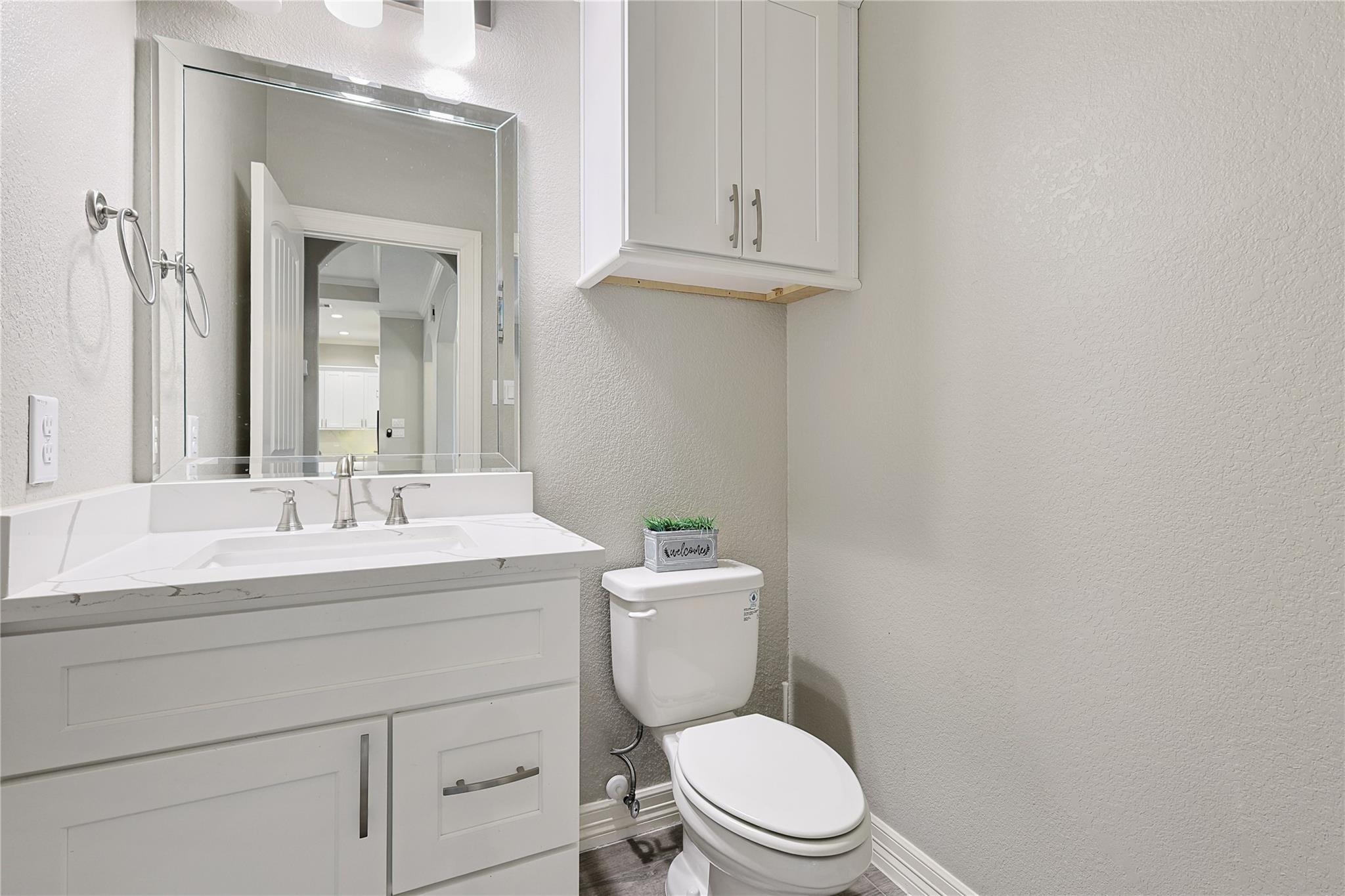 642 Parthenon Place New Caney, TX 77357 - Photo 22 of 30 a bathroom with a toilet a sink and mirror