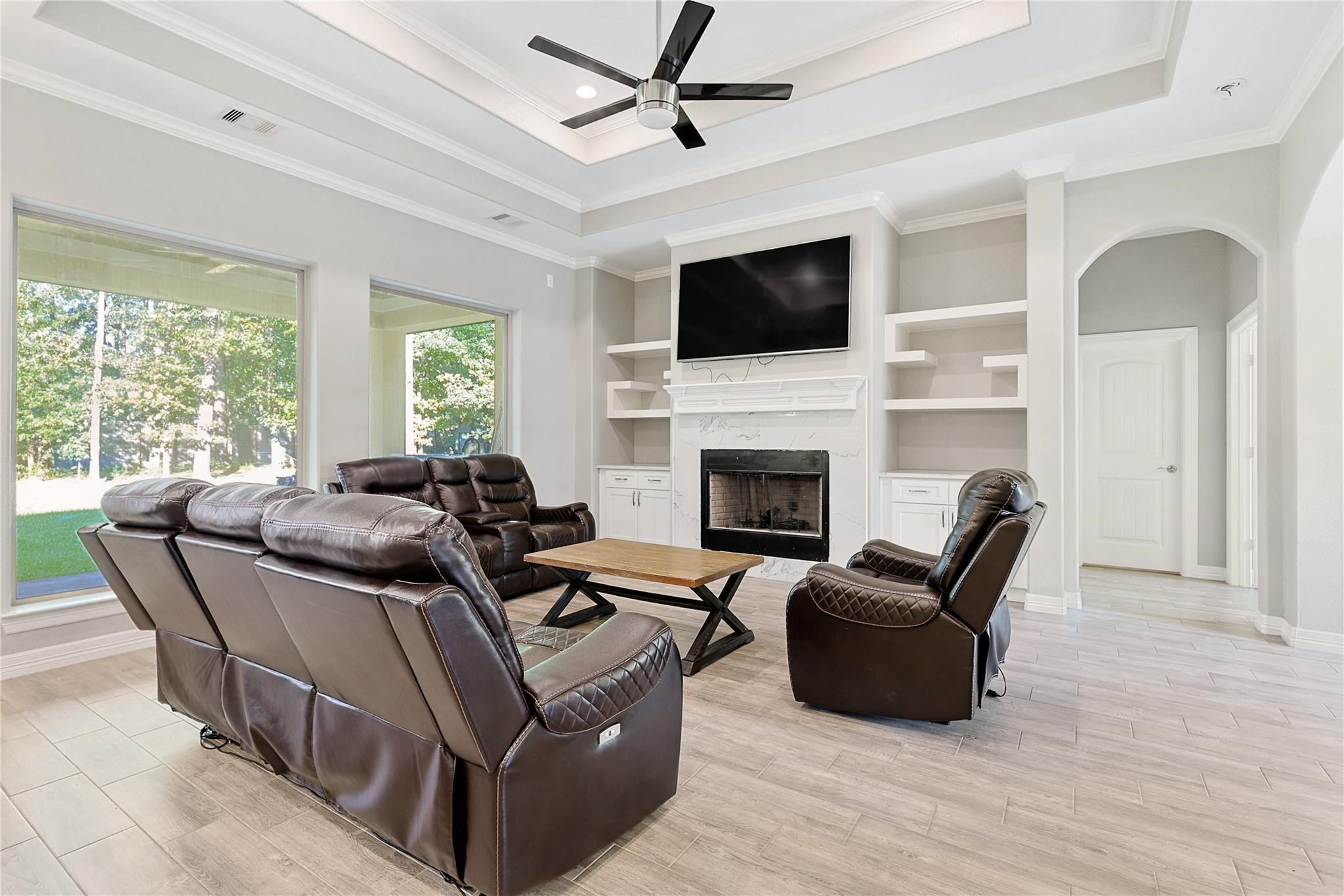642 Parthenon Place New Caney, TX 77357 - Photo 4 of 30 a living room with furniture a flat screen tv and a fireplace
