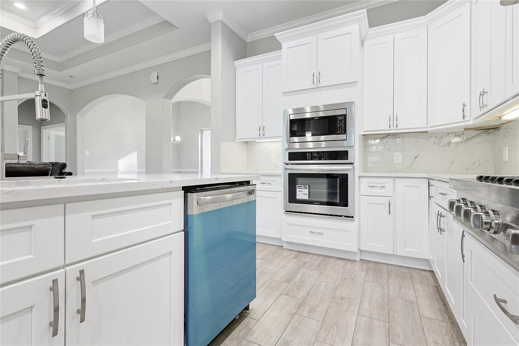 642 Parthenon Place New Caney, TX 77357 - Photo 8 of 30 a kitchen with granite countertop white cabinets and stainless steel appliances