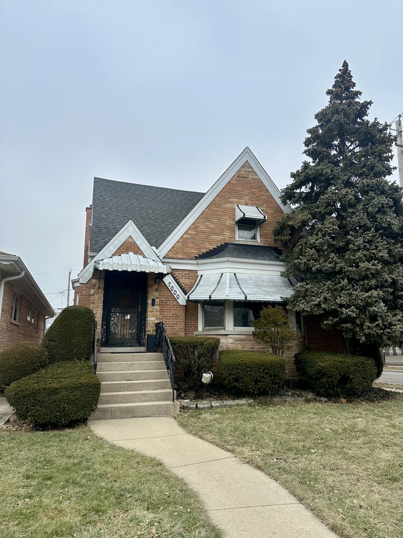 7000 West Henderson Street Chicago, IL 60634 - Photo 1 of 30 a front view of a house with a yard