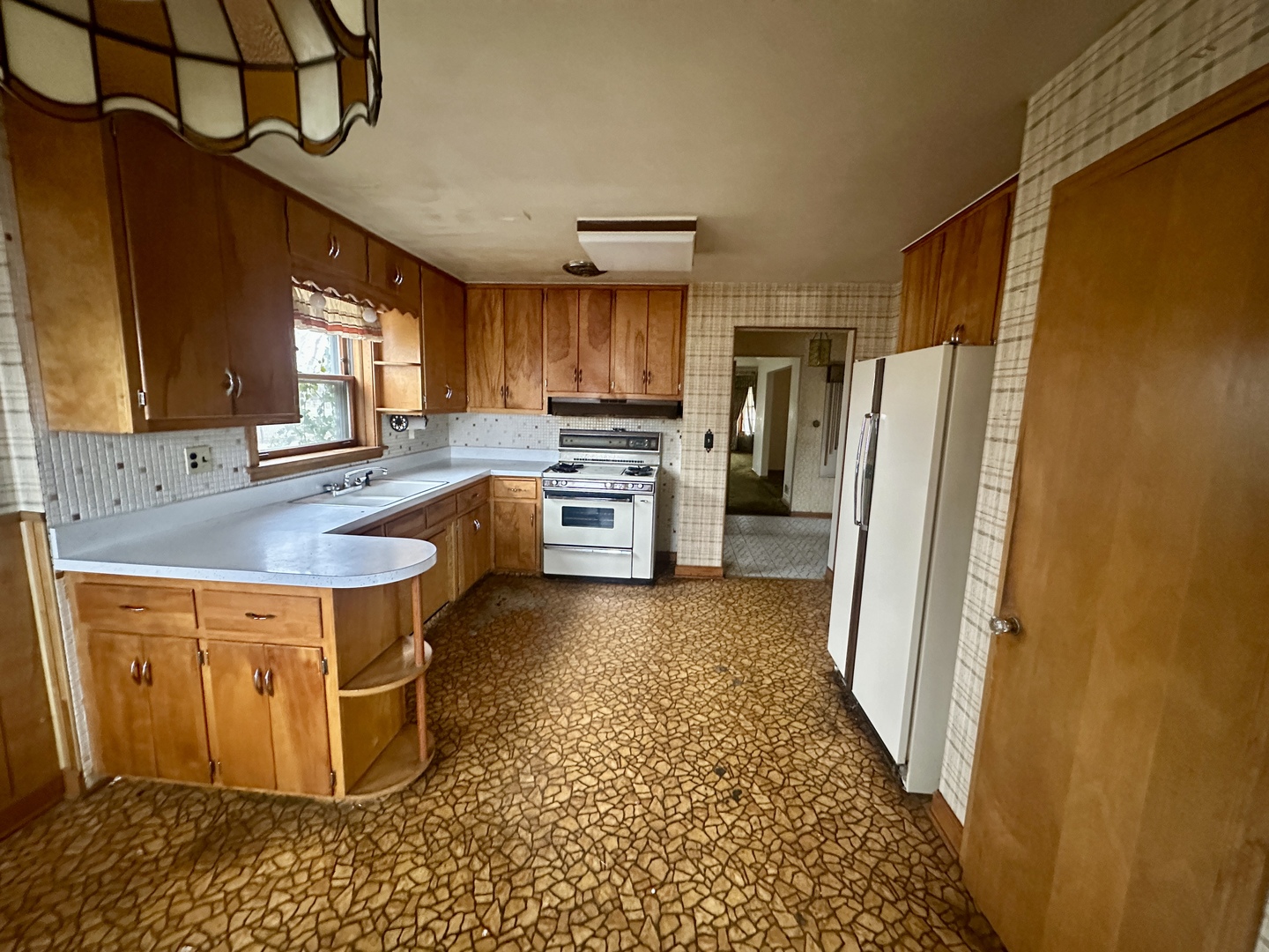 7000 West Henderson Street Chicago, IL 60634 - Photo 11 of 30 a kitchen with stainless steel appliances granite countertop a refrigerator a sink a stove a washer dryer and a dining table