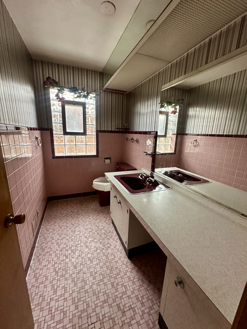 7000 West Henderson Street Chicago, IL 60634 - Photo 22 of 30 a kitchen with a sink a stove and a window