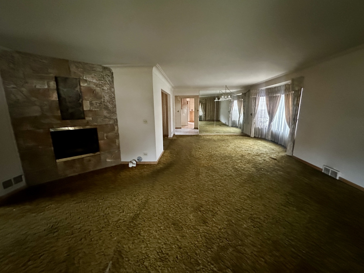 7000 West Henderson Street Chicago, IL 60634 - Photo 4 of 30 a view of an empty room with a fireplace and a window
