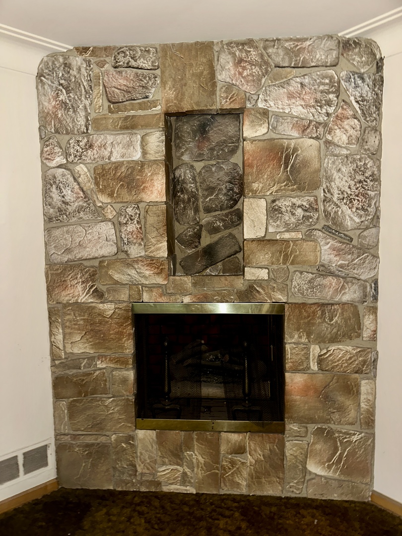 7000 West Henderson Street Chicago, IL 60634 - Photo 5 of 30 a room with a fireplace