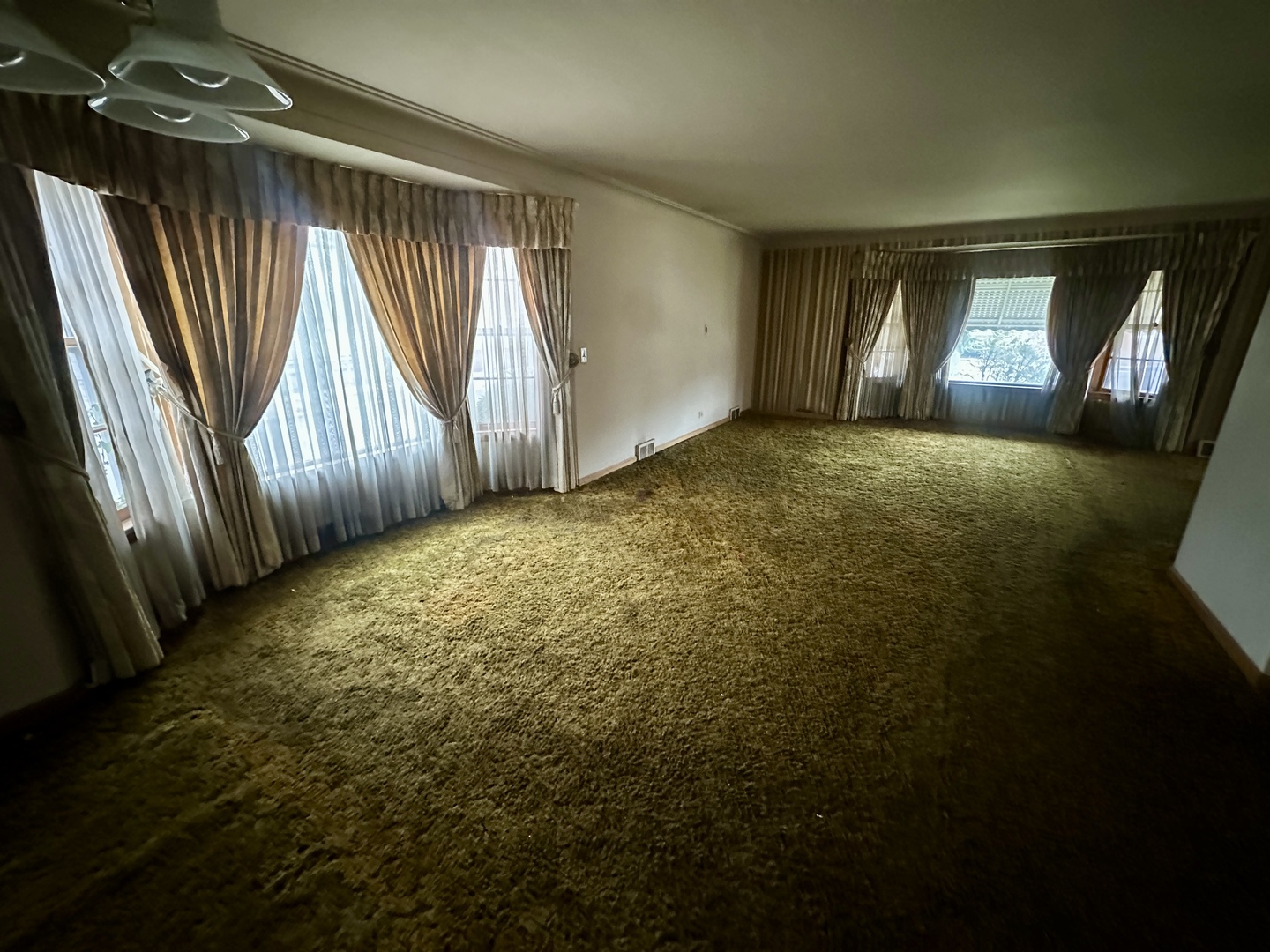 7000 West Henderson Street Chicago, IL 60634 - Photo 6 of 30 a view of empty room with wooden floor and fan