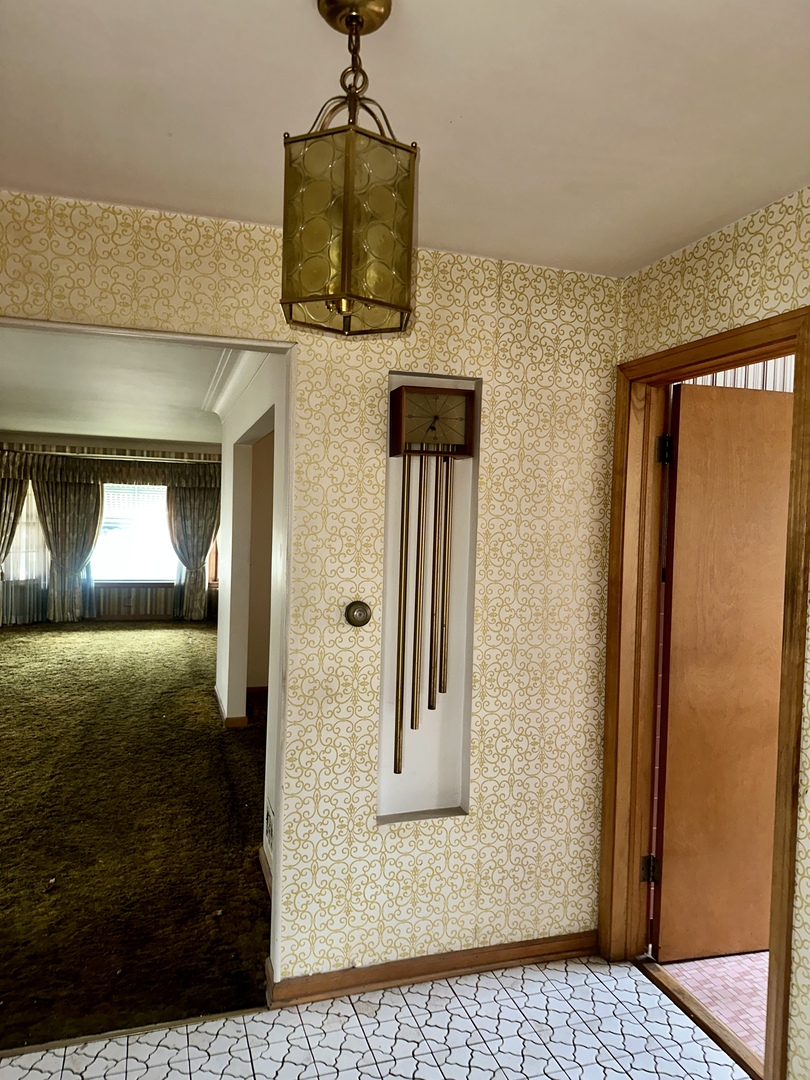 7000 West Henderson Street Chicago, IL 60634 - Photo 8 of 30 a view of a hallway with wooden floor and a living room