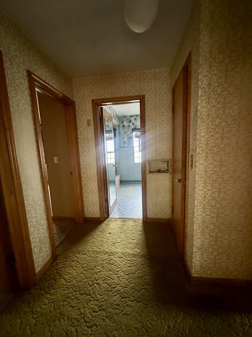 7000 West Henderson Street Chicago, IL 60634 - Photo 10 of 30 a view of a hallway with wooden floor and a livingroom